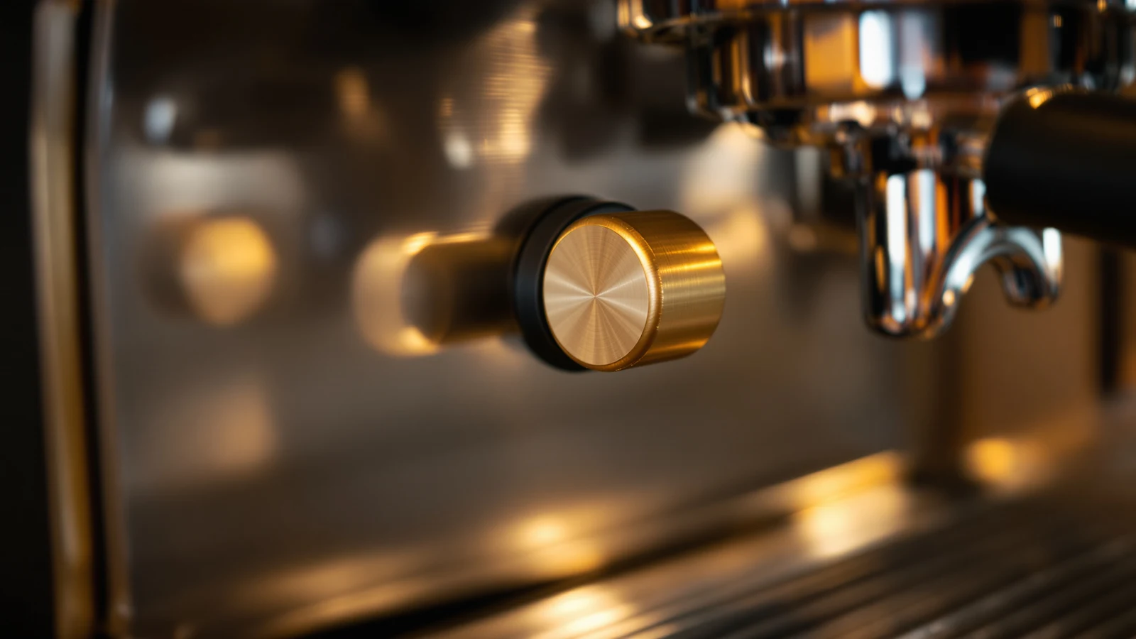 Close-up of an espresso machine's brass over-pressure valve dial beside a portafilter mid-extraction